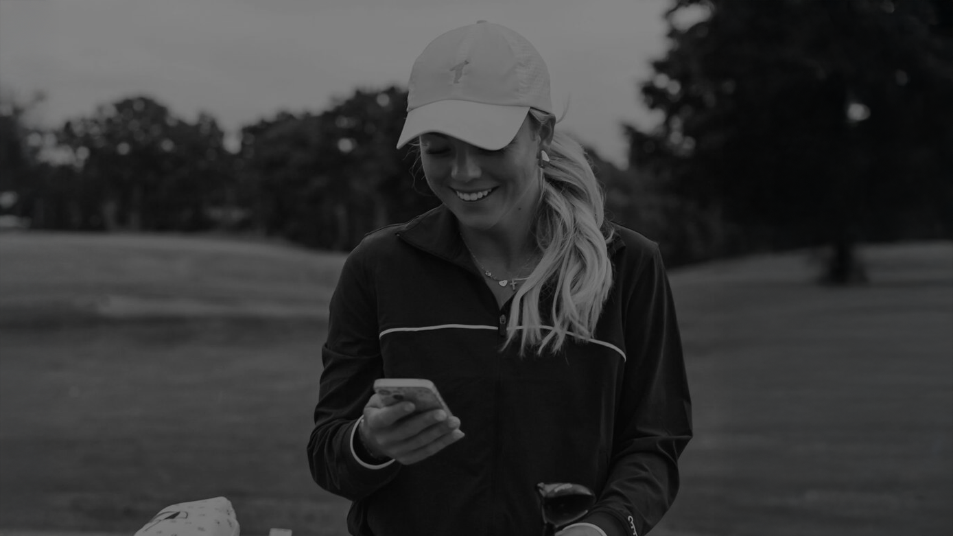 A golfer on her phone taking an online fitting survey