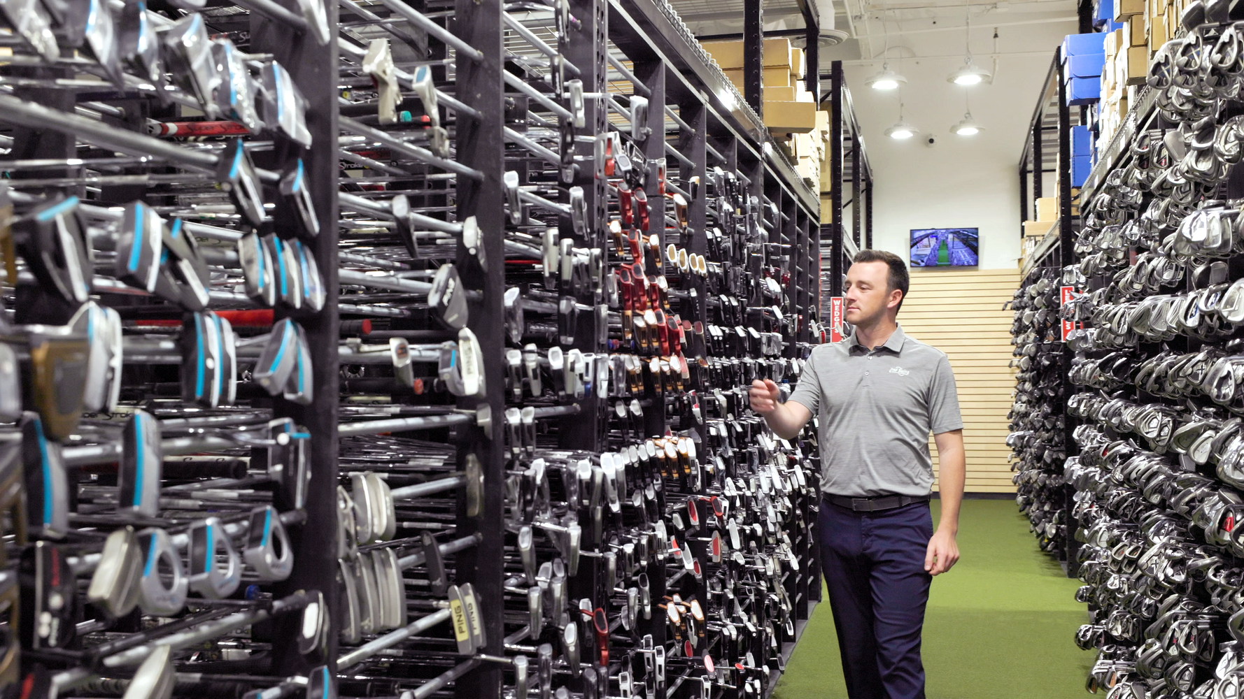 a man perusing the widest selection of golf clubs ever