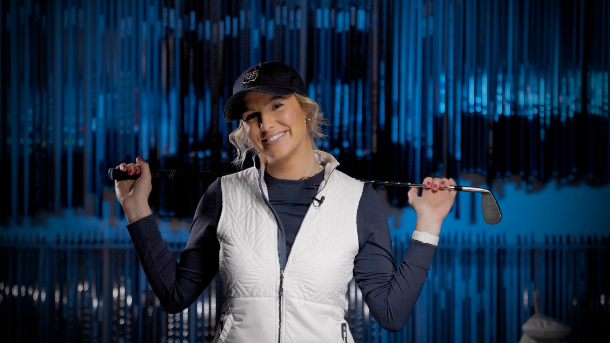 a golfer smiling in a fitting bay