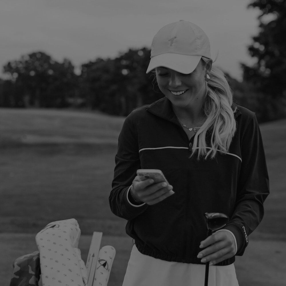 A golfer on her phone taking an online fitting survey